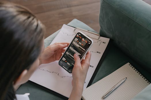 Nurse using a smartphone for investments